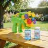 4-Head Bubble Gun Toy with colorful bubble solution bottles on a sunny outdoor table.
