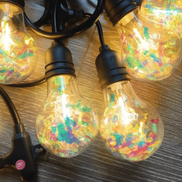 Outdoor LED String Lights illuminating colorful decorations for outdoor gatherings and events.