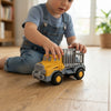 Child playing with a Friction-Powered Utility Cargo Truck Toy on wooden floor, engaging in active construction-themed play.