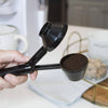 2 in 1 Coffee Scoop and Funnel being used to measure coffee grounds, showcasing its dual functionality in a kitchen setting.