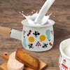 Small Enamel Milk and Butter Warming Pot with milk pouring and dessert on table