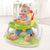 A baby happily seated in an Adjustable Portable Baby Feeding Chair, engaging with food while secured and comfortable.