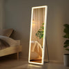 Full Length LED Backlit Wall Mounted Mirror with ambient lighting in a modern bedroom.