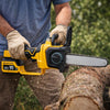 Man using a Cordless Telescopic Chainsaw 13 Inch Bar Tool-Free Tension on a log outdoors.