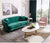Oval Faux Marble Coffee Table with Gold Metal Base in a stylish modern lounge setting with a green velvet sofa and pink chair.