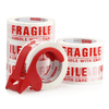Fragile Warning Packing Tape rolls and dispenser for safe packaging and shipping with 'Fragile' warning.