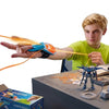 A child playing with a Glow-in-the-Dark String Launcher Toy, demonstrating its shooting action at a desk.