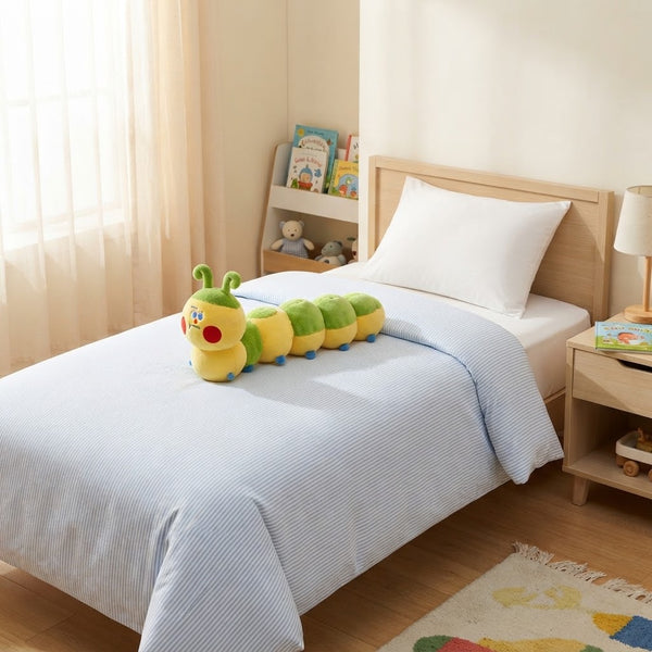 Caterpillar Plush Throw Pillow on a bed, perfect for nurseries and kids' rooms, offering colorful decor and comfort.
