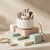 360-Degree Rotating Desktop Storage Bucket with makeup brushes organized on pastel boxes.