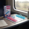 Mini Magnetic Chess Set with Folding Board displayed in a train, showcasing a compact and portable design for on-the-go play.