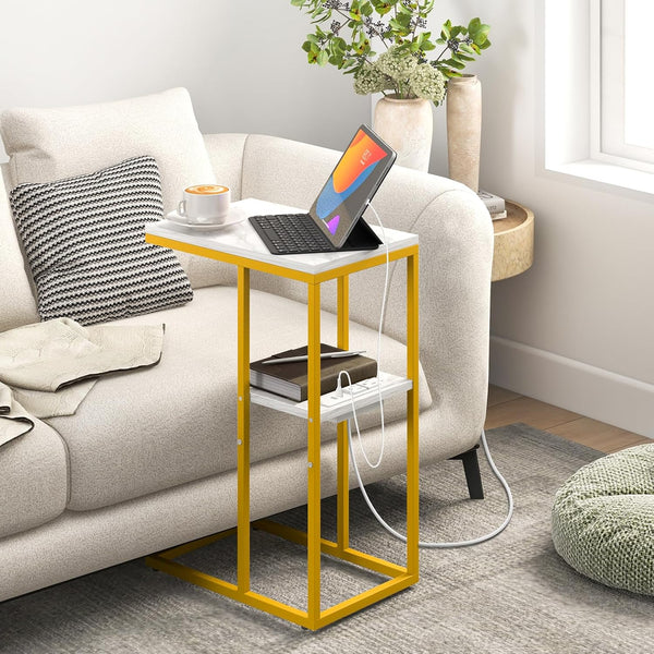 C Shaped Side Table with Charging Station holding a laptop and coffee beside a sofa.