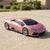 Remote Control Sports Toy Car in pink color parked on a driveway, showcasing its sleek design and realistic details.