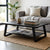 Industrial Minimalist Wood & Metal Coffee Table with books and a mug in a stylish living room setting.