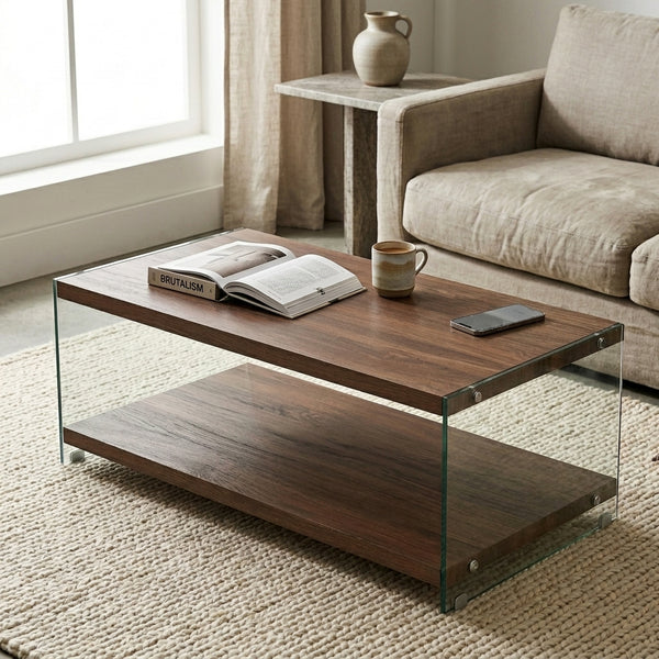 Rectangle Wooden Top Coffee Table with glass legs, styled with a book and coffee cup in a contemporary living room.