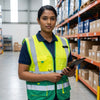 Woman wearing a Pioneer Signaling Vest in a warehouse, highlighting visibility and safety in logistics operations.