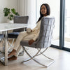 Grey Upholstered Dining Chair with Silver Frame, stylish seating solution in modern dining area.