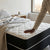 Person testing the comfort of the 1.8M Medium Firm Support Foam Mattress in a modern bedroom setting.