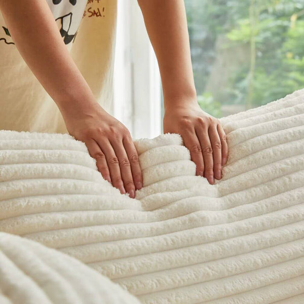 Person gently pressing on the soft fabric of a Round Corduroy Lounge Chair for Cozy Spaces.