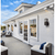 Glow Square Outdoor Wall Light mounted on modern white exterior wall, illuminating outdoor seating area.