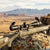 Rifle Scope on a rifle with a scenic mountainous background, showcasing its design and functionality.