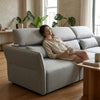 SF-622B Modular Fabric Couch in a cozy living room, featuring adjustable headrests and a relaxed female sitting comfortably.