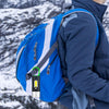 Portable Waterproof COB LED Rechargeable Keychain Light attached to a blue backpack on a person in a snowy landscape.