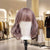 Wood Mannequin Head Wig Display Stand showcasing a stylish purple wig in a boutique setting.