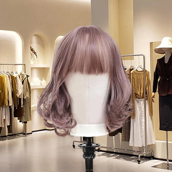 Wood Mannequin Head Wig Display Stand showcasing a stylish purple wig in a boutique setting.