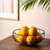 Geometric Iron Fruit Storage Basket with fresh oranges, enhancing airflow for longer freshness on a wooden table.