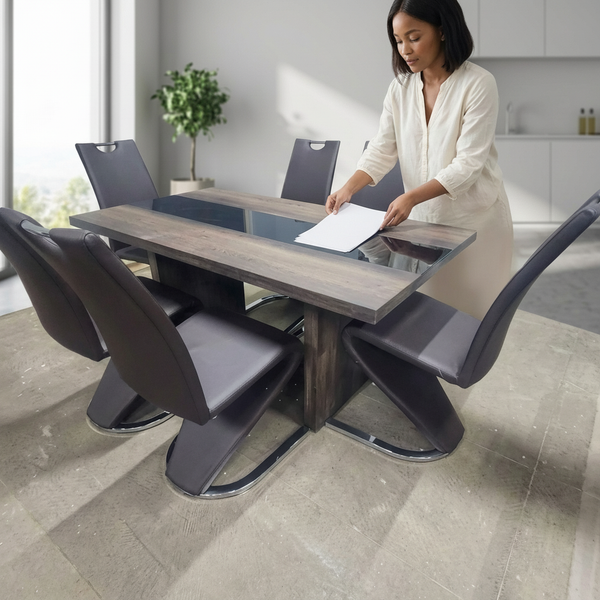 Black with Marble Lining Dining Room Table Set with a woman arranging papers on the table in a well-lit space.