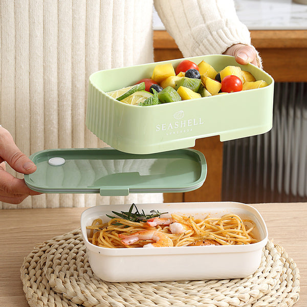 Collapsible Double-Layer Lunch Box holding pasta and fresh vegetables on a table.