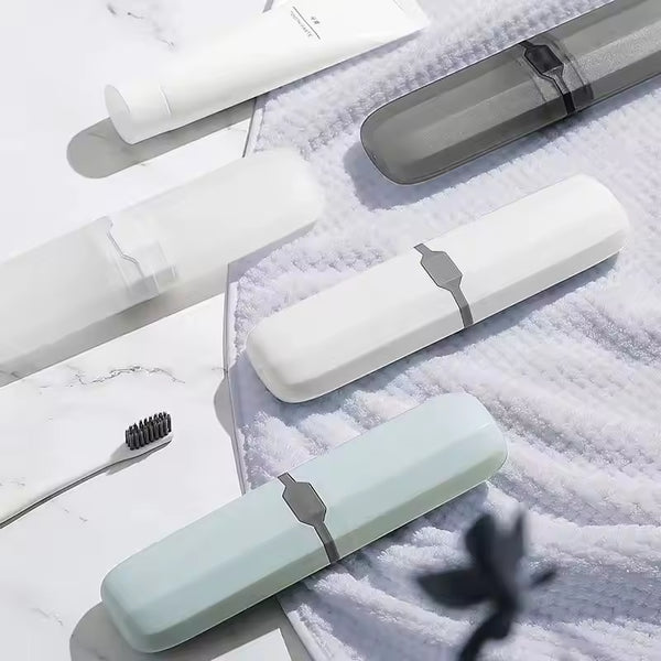 Compact Travel Toothbrush & Utensil Storage Case in various colors on a soft surface with a toothbrush.