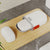 Compact Waterproof Travel Soap Case with Carry Handle placed on wooden surface next to soap bar.