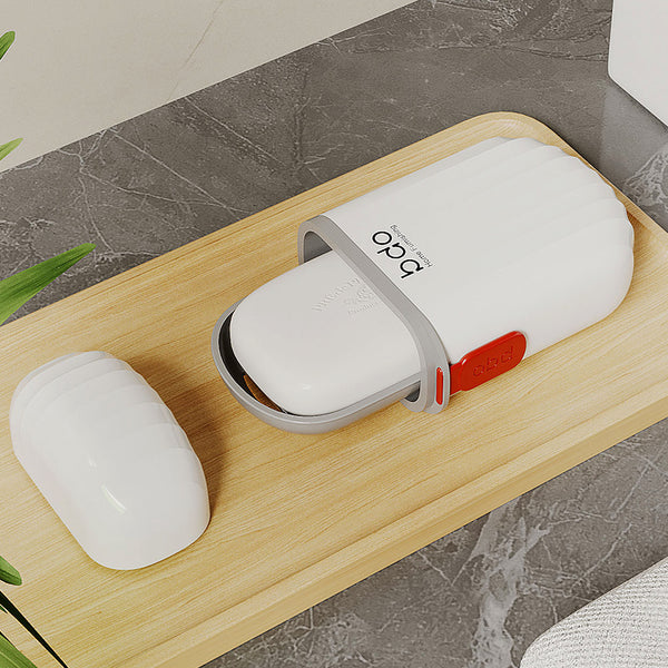 Compact Waterproof Travel Soap Case with Carry Handle placed on wooden surface next to soap bar.