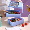 Double-Layer 1200 ml Plastic Lunch Box with Spoon holding stacked compartments filled with fruits.