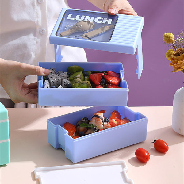 Double-Layer 1200 ml Plastic Lunch Box with Spoon holding stacked compartments filled with fruits.