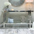 Double Tier Silver Console Table styled with decorative items and a mirror, perfect for modern interiors.