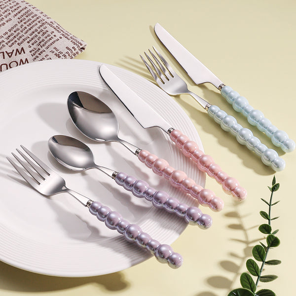 Elegant Pearl-Handled Stainless Steel Cutlery Set displayed on a plate featuring colorful handles in pastel shades.