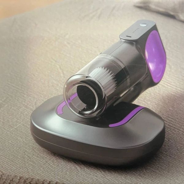 Mite Remover 2 in 1 Cordless Vacuum Cleaner on a couch, showcasing its sleek design and vacuum head.