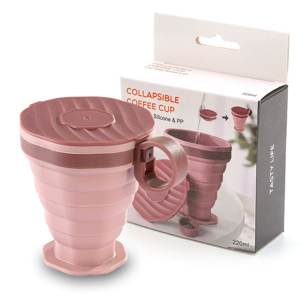 Foldable silicone travel cup in pink, 220 ml capacity, displayed with packaging for easy portability and storage.