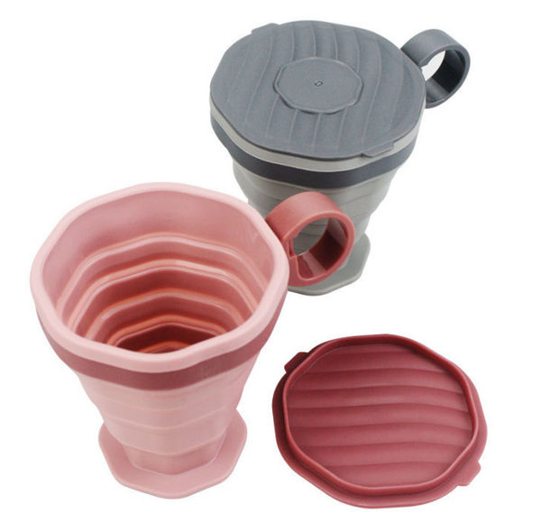 Foldable silicone travel cup in pink and grey, showcasing its collapsible design and lightweight, perfect for travel.