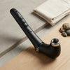 Folding Handheld Body Massager featuring a sleek black design on a wooden surface background.