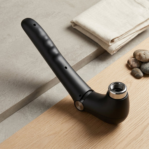 Folding Handheld Body Massager featuring a sleek black design on a wooden surface background.