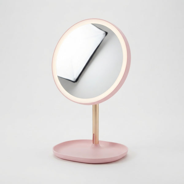 Round Makeup Mirror with Storage Tray featuring a pink freestanding design and integrated storage tray.