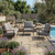 3-Piece Outdoor Patio Lounge Set arranged by a pool, surrounded by flowers and greenery for stylish outdoor relaxation.