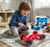 Child playing with remote-controlled 5-Way 2.4G RC Torsion Car Receiver Board in a colorful playroom.