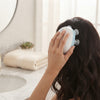A person using the Electric Scalp Massage Brush with 4 Massage Heads for a relaxing scalp massage at home.