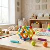 Rainbow Magnetic Construction Sticks & Balls Set displayed on a table in a colorful playroom, showcasing creative building shapes.
