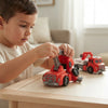 Boy playing with 2-in-1 Take-Apart Fire Truck Robot Toy, assembling fire truck components on a table.