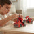 Boy playing with 2-in-1 Take-Apart Fire Truck Robot Toy, assembling fire truck components on a table.